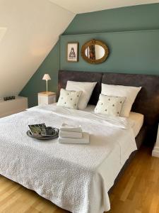 a large white bed with a tray of food on it at Charmante Penthouse Wohnung in Krefeld