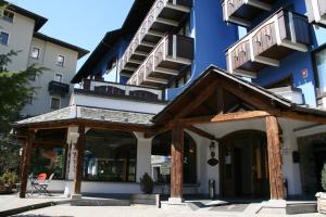 
a large building with a large window at Hotel Baita Clementi in Bormio
