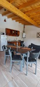 a dining room table and chairs in a kitchen at Departamentos San Benito in Malargüe