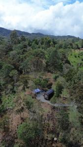 an aerial view of a field with a truck at Tiny House Minimalista en la Naturaleza, El Retiro in El Retiro