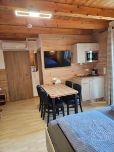 a kitchen and dining room with a table and chairs at Gästehaus Rana in Rust