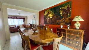a dining room with a table and a painting on the wall at House with 5 bedrooms near Brussels in Wemmel