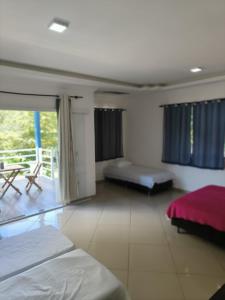 Ένα ή περισσότερα κρεβάτια σε δωμάτιο στο Baixo Sana pousada