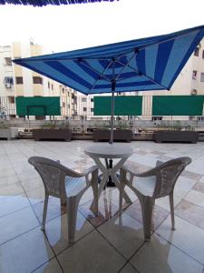 a table and chairs with an umbrella on a patio at résidence sara in Fez