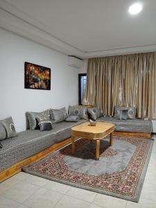 a living room with a couch and a table at résidence sara in Fez +2 photos