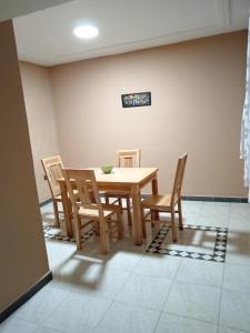 a dining room with a wooden table and chairs at résidence sara in Fez