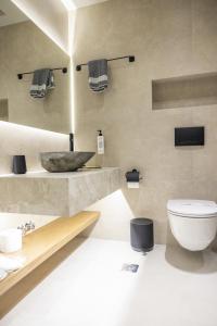 a bathroom with a sink and a toilet at Polyzos Luxury Suites Meteora #4 - Adults Friendly in Kalabaka