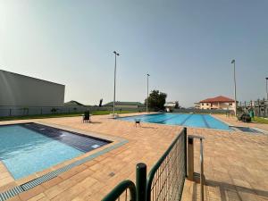 a large swimming pool on a building at AndBert Lodge Gh in New Weija