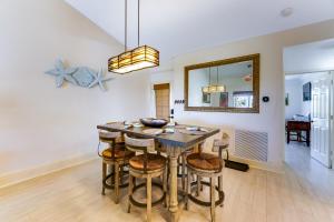 a dining room with a table and stools at Turtle Caye in Sanibel +14 photos
