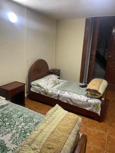a room with two beds and a mirror in it at Kouta hotel in Alexandria