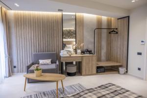a room with a desk and a chair and a table at Polyzos Luxury Suites Meteora #7 - Adults Friendly in Kalabaka