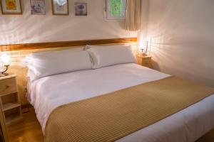 Łóżko lub łóżka w pokoju w obiekcie Oriente Suites