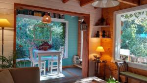 a porch of a house with a table and a window at Dodo House in Villa La Angostura +67 photos