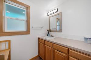 a bathroom with a sink and a mirror at Cottage By The Sea Nedonna Beach Getaway in Rockaway Beach +18 photos