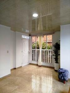 a living room with a large window and a door at Apto Cerca Nueva clinica y Zona Turística Girón in Girón