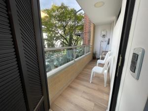 an open door to a balcony with a view of a balcony at En Laureles con ascensor , balcón y muy bien ubicado en laureles Medellín , EL BARRIO MAS COOL DEL MUNDO in Medellín