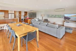 a living room with a table and a couch at Hume Parade 19, Unit 2, Currimundi in Kawana Waters