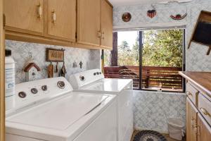 una cocina con electrodomésticos blancos y una ventana en Mountain Hideaway on Maryland by Big Bear Vacations, en Big Bear Lake