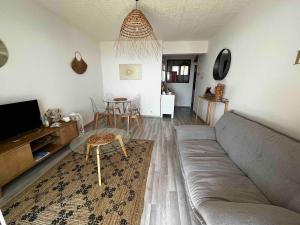 a living room with a couch and a table at Beautiful beachfront apartment in Carry-le-Rouet