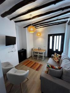 a living room with a couch and a table at Casa María Lanjarón in Lanjarón