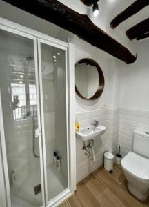 a bathroom with a shower and a toilet and a sink at Casa María Lanjarón in Lanjarón