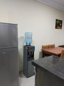 La cuisine est équipée d'un réfrigérateur et d'un bol au-dessus d'un four. dans l'établissement شاليه للايجار في العين السخنة قرية بالم بيتش للعائلات فقط, à Ain Sokhna