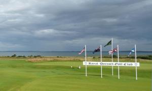 a golf course with flags on a green field at No1Dornoch in Dornoch