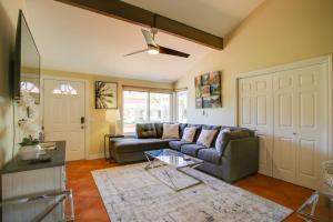 a living room with a couch and a ceiling fan at Townhome with Pool Access, Near Dtwn Palm Springs! in Palm Springs