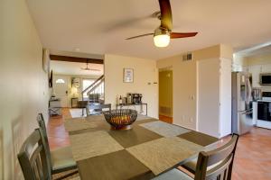 a kitchen and dining room with a table and a ceiling fan at Townhome with Pool Access, Near Dtwn Palm Springs! in Palm Springs