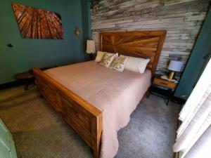 a bedroom with a large wooden bed in a room at A Charming Mountain Getaway in Historic Como in Como