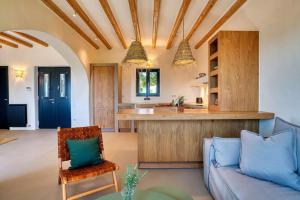 a living room with a couch and a kitchen at Villa Hestia - Full estate in Kóstos