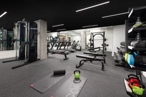 a gym with several treadmills and machines at Timbri Hotel San Francisco, Curio Collection by Hilton in San Francisco +101 photos