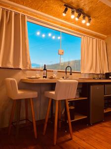 a kitchen with a counter and a large window at Cabana bela vista in Cunha +53 photos