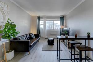 a living room with a couch and a table at Nice unit in heart of downtown balcony view in Montréal