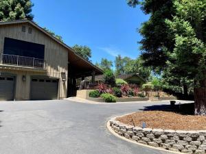 a driveway leading to a house with a garage at King Bed-Peaceful Modern Cottage-Garden Setting in Carmichael