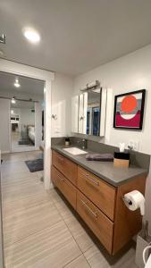 a bathroom with a sink and a mirror at King Bed-Peaceful Modern Cottage-Garden Setting in Carmichael