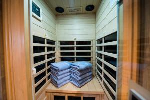 a walk in closet with blue folded towels in it at Smoky Oasis, Hot Tub, Luxury Sauna, Fire Pit, Arcade Games, Free Pets in Sevierville