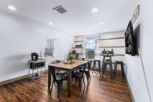 a kitchen and dining room with a table and chairs at River Hotel Groups Main Street Games Firepit in Boerne