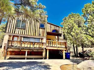 a large wooden house with a balcony and trees at Timber Terrace .9 mi Downtown pet friendly in Prescott