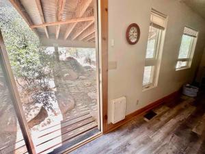 a room with a door to a balcony with a clock at Timber Terrace .9 mi Downtown pet friendly in Prescott +30 photos