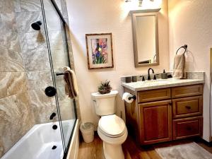 a bathroom with a shower and a toilet and a sink at Villa Hermosa- Guest Quarters in Prescott +13 photos