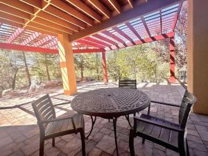 a patio with a table and chairs and a pergola at Villa Hermosa- Guest Quarters in Prescott