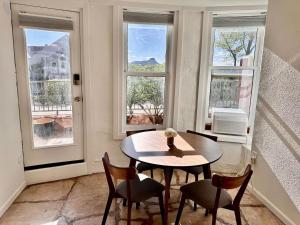 a dining room with a table and chairs and windows at 1900 Suite Downtown Views pet friendly in Prescott +8 photos