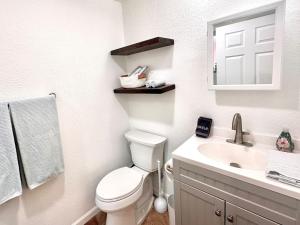 a white bathroom with a toilet and a sink at 1900 Suite Downtown Views pet friendly in Prescott