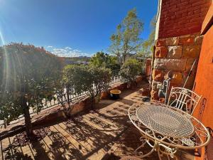 a patio with a table and chairs and trees at 1900 Suite Downtown Views pet friendly in Prescott