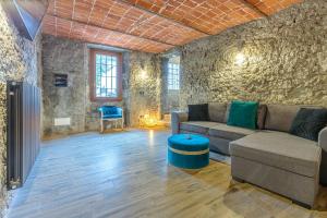 a living room with a couch and a table at La Cascina Amore con jacuzzi e sauna by Halldis in Ozzano Monferrato