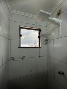 a bathroom with a shower and a window at Apartamento Central em Alfenas in Alfenas +21 photos