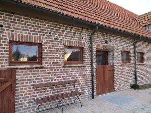a brick building with a bench in front of it at Holiday Home 't Hof der Witte Damen in Veurne