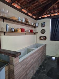 a bathroom with a large tub in a room at Pousada Oceanica Marica in Maricá