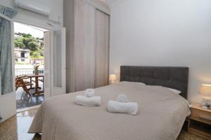 a bedroom with a bed with two towels on it at Sunrise Apartment By Athens Airport in Spáta